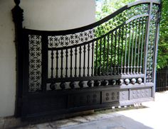 a wrought iron gate on the side of a building