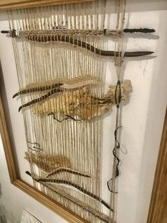 an image of a wall hanging with feathers