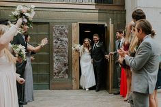 a bride and groom leaving the church after their wedding ceremony with confetti in hand