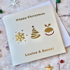 a christmas card with the words happy christmas louise and danielle on it next to some decorations