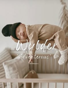 a baby is sleeping in a crib with the words wonder and adventure above it