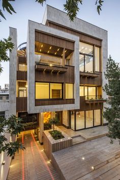 an apartment building with stairs leading up to the second floor and two stories above it