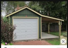 an image of a small garage with the door open and brick walkway leading up to it