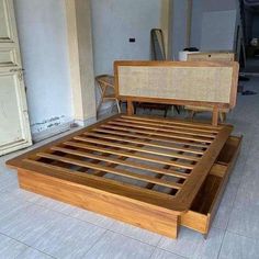 a wooden bed frame with wicker headboard and foot board on tiled flooring