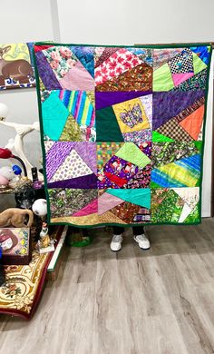 there is a very large colorful quilt on the floor