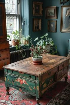 a living room with an old table and potted plants on the coffee table in front of it