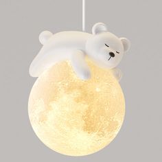 a light that is shaped like a polar bear sleeping on the moon with its eyes closed