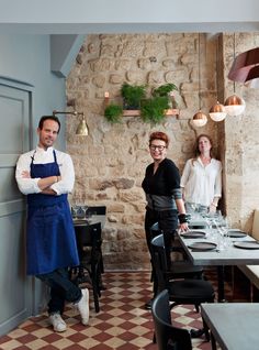 two people standing next to each other in a restaurant