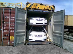 two cars are in the back of a shipping container