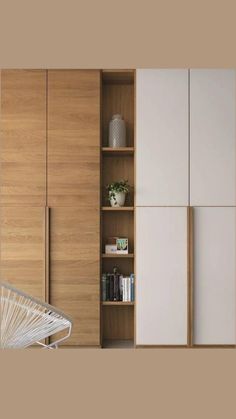 a white chair sitting in front of a wooden cabinet