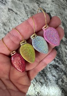 three glitter heart shaped earrings in gold, silver and pink