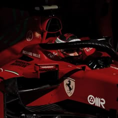 a man sitting in a red race car