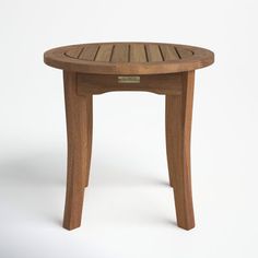 a small wooden table sitting on top of a white floor