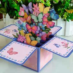 there are many colorful butterflies on this card holder that is decorated with blue and pink trimmings