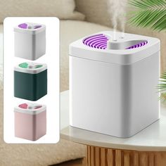 an air purifier sitting on top of a table next to a plant