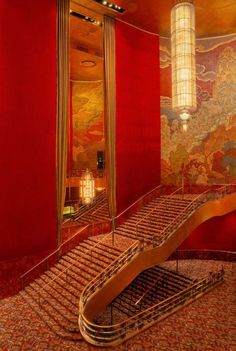 a staircase in a room with red walls