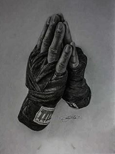 a black and white drawing of a person's hand holding a pair of boxing gloves