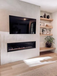 a television mounted on the wall above a fireplace