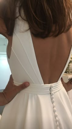 the back of a woman's white dress