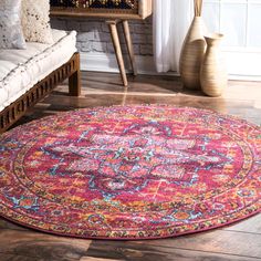 a pink and blue area rug in a living room