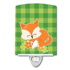 a cute little fox with flowers on it's tail is sleeping on a green plaid pattern night light