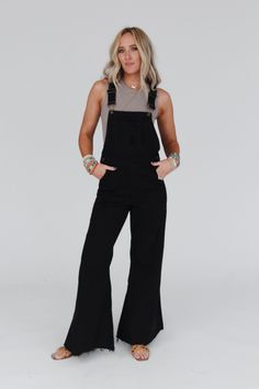 The ultimate wide leg jumpsuit is here, the Milly Distressed Hem Wide Leg Overalls! You are going to wear these year-round because of the comfortable denim fabric, the perfect wide leg silhouette, distressed details throughout for added style, functional pockets, and classic overall-style adjustable straps. Pair with a cute top like the High Neck Racerback Brami for a boho-chic look ready for any occasion. *Due to lighting and differences in monitors, actual colors may vary slightly from what ap Overalls With Mesh Top, Cute Outfits With Overalls, What To Wear With Overalls, Fitted Overalls, Black Overalls Outfit, Styling Overalls, Women Overalls, Wide Leg Overalls, Free People Overalls