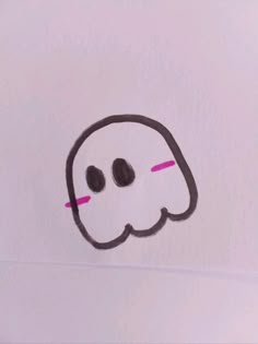 a white piece of paper with a drawing of a ghost on it's face