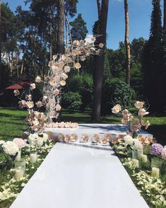 an outdoor ceremony with flowers and candles