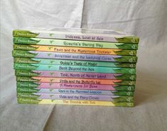 a stack of children's books sitting on top of a white sheet