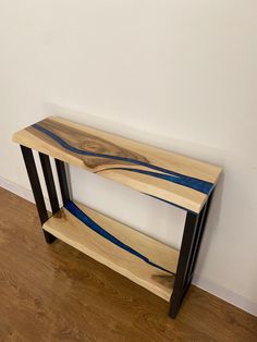 a wooden shelf sitting on top of a hard wood floor next to a white wall