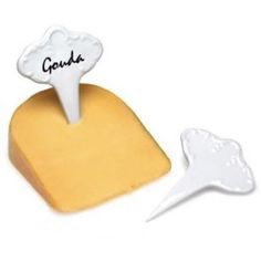 a piece of cheese with the word gourda written on it next to a slice of cheese