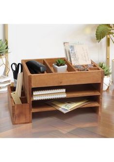 a wooden desk with two compartments holding office supplies