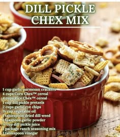 two red bowls filled with chex mix on top of a wooden table