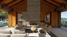 a living room filled with furniture and a fire place next to a stone wall covered in wood