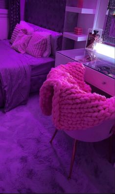 a bed room with a neatly made bed and purple lighting