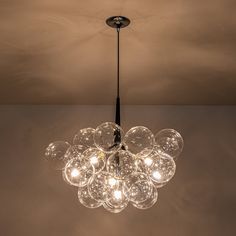 a chandelier hanging from the ceiling in a room with no one around it