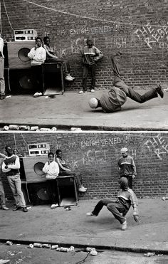 black and white photograph of man falling off his skateboard in front of brick wall