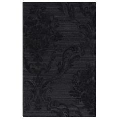 a black rug with an intricate design on the front and back side, in dark colors