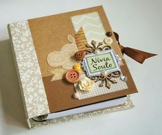 an open book with buttons and other things on the cover, sitting on a table