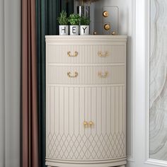 a white chest of drawers sitting next to a window