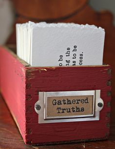 a red wooden box with some papers in it