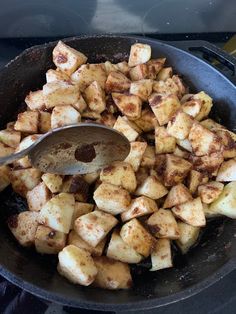 the food is being cooked in the skillet on the stove with a spatula