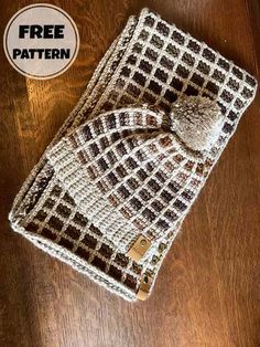 a brown and white knitted bag sitting on top of a wooden table next to a free pattern