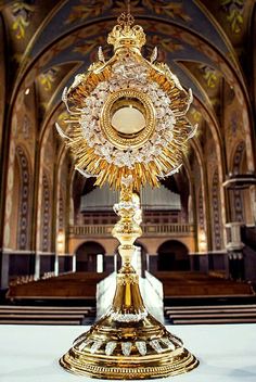 an ornate gold clock in the middle of a church