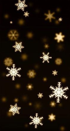 snowflakes are flying in the air on a black background