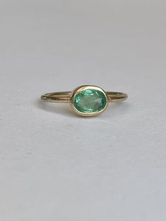 One of a kind, handmade apple green emerald ring. Stones: 1.0ct emerald Material: 9ct Solid Yellow Gold Size: M or 52mm circumference Rink Shank Width: 1,5mm Engagement Ring Emerald Green, Green Oval Ring With Bezel Setting, Oval Green Ring With Bezel Setting, Oval Emerald Birthstone Ring In Fine Jewelry Style, Oval Emerald Ring With Bezel Setting, Classic Oval Green Sapphire Ring, Green Oval Sapphire Promise Ring, Green Oval Jewelry With Bezel Setting, Classic Green Oval Sapphire Ring