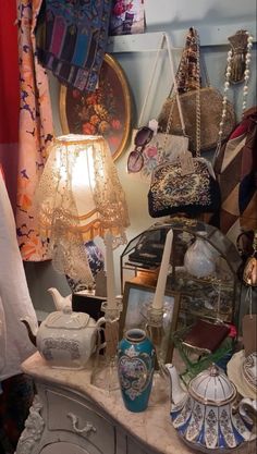 there are many items on the table in this room, including purses and teapots