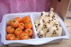 two white dishes filled with oranges and bananas