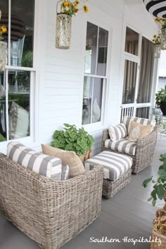 two wicker chairs sitting on the front porch