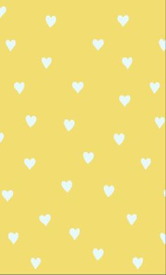 a yellow background with white hearts on it